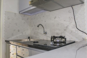 Fridge, stovetop, cookware/dishes/utensils - Comfy 2BR Apartment Bassura City near Shopping Mall (Jakarta)