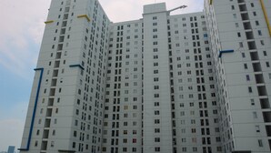 A multi-story residential building with a uniform facade, numerous windows, and a flat roof.