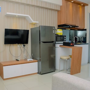 Fridge, stovetop, cookware/dishes/utensils - Elegant and Comfy 2BR above Mall at Bassura City Apartment (Jakarta)