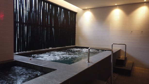 A modern spa area with a hot tub and a separate water feature. - Modern Style Studio Apartment at Azalea Suites with City View (Cikarang)