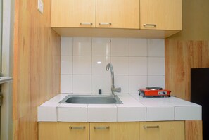 Room | Private kitchen | Fridge, stovetop, cookware/dishes/utensils - Cozy Studio Apartment at Margonda Residence 2 near Universitas Indonesia (Depok)