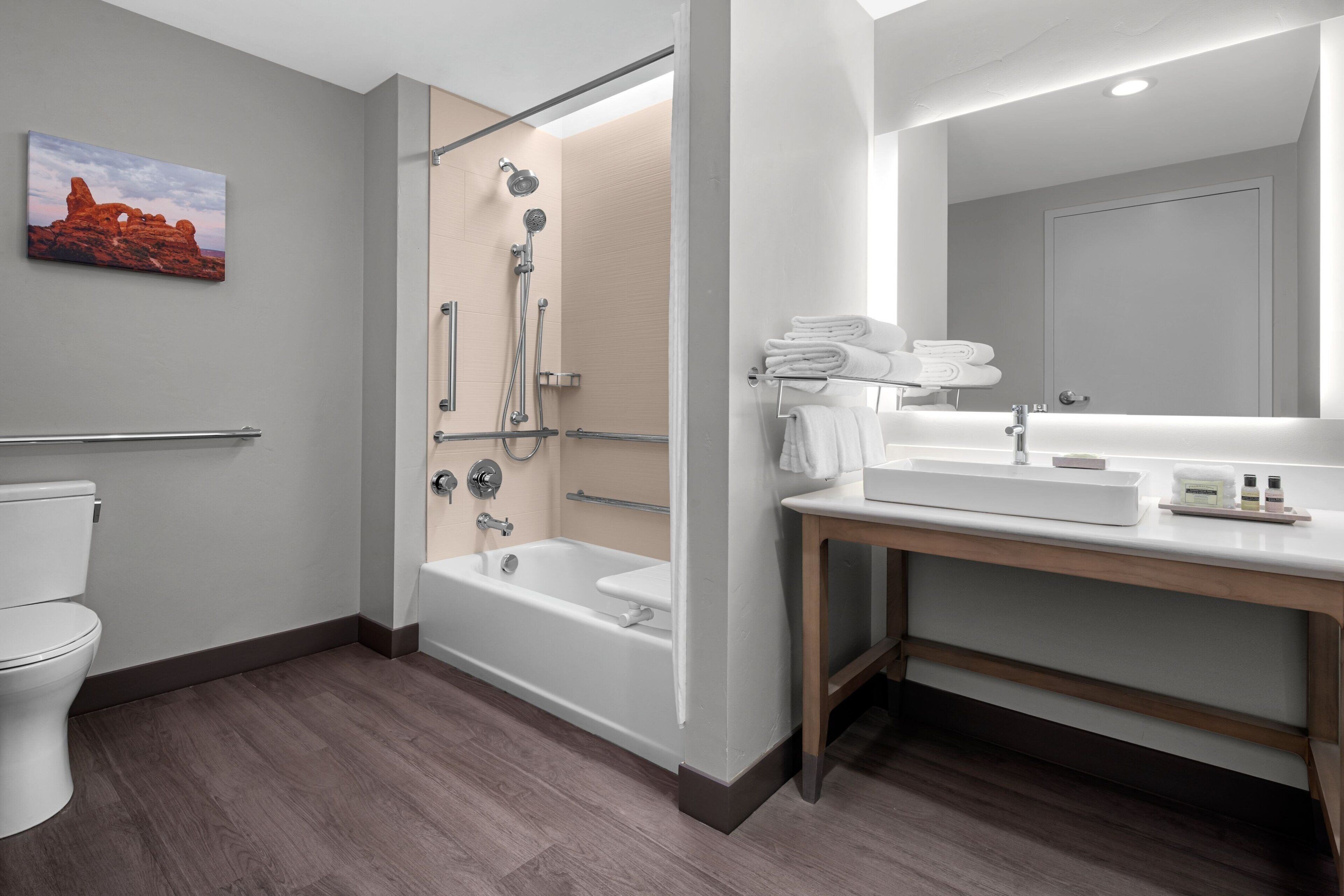 A modern bathroom with a shower, toilet, and sink area.