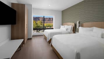 Premium bedding, desk, laptop workspace, blackout drapes