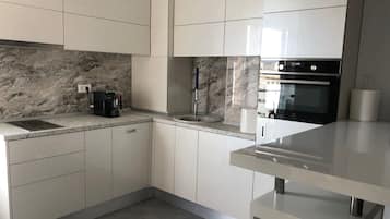 Design Apartment | Private kitchen | Full-size fridge, microwave, oven, stovetop