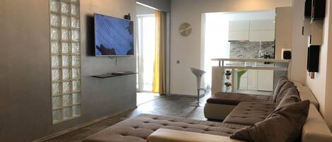 Design Apartment | Living area | 55-inch LED TV with cable channels, TV, Netflix
