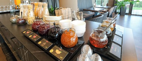 A breakfast buffet with various food options and condiments.