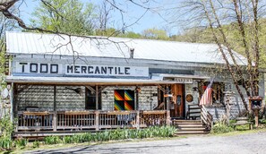 A rustic building with a sign reading "TODD MERCANTILE" and a "BAKERY" sign.