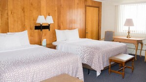 A hotel room with two beds, a wooden headboard, a desk with a chair, and a window with blinds. - Park Lake Motel (Perry)