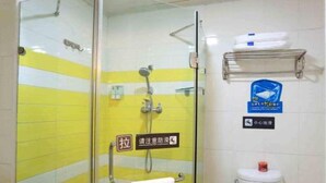 A bathroom with a glass partition, a yellow and white tiled wall, a hand dryer, and a towel rack. - 7 Days Inn Yiyang Center Branch (Yiyang)