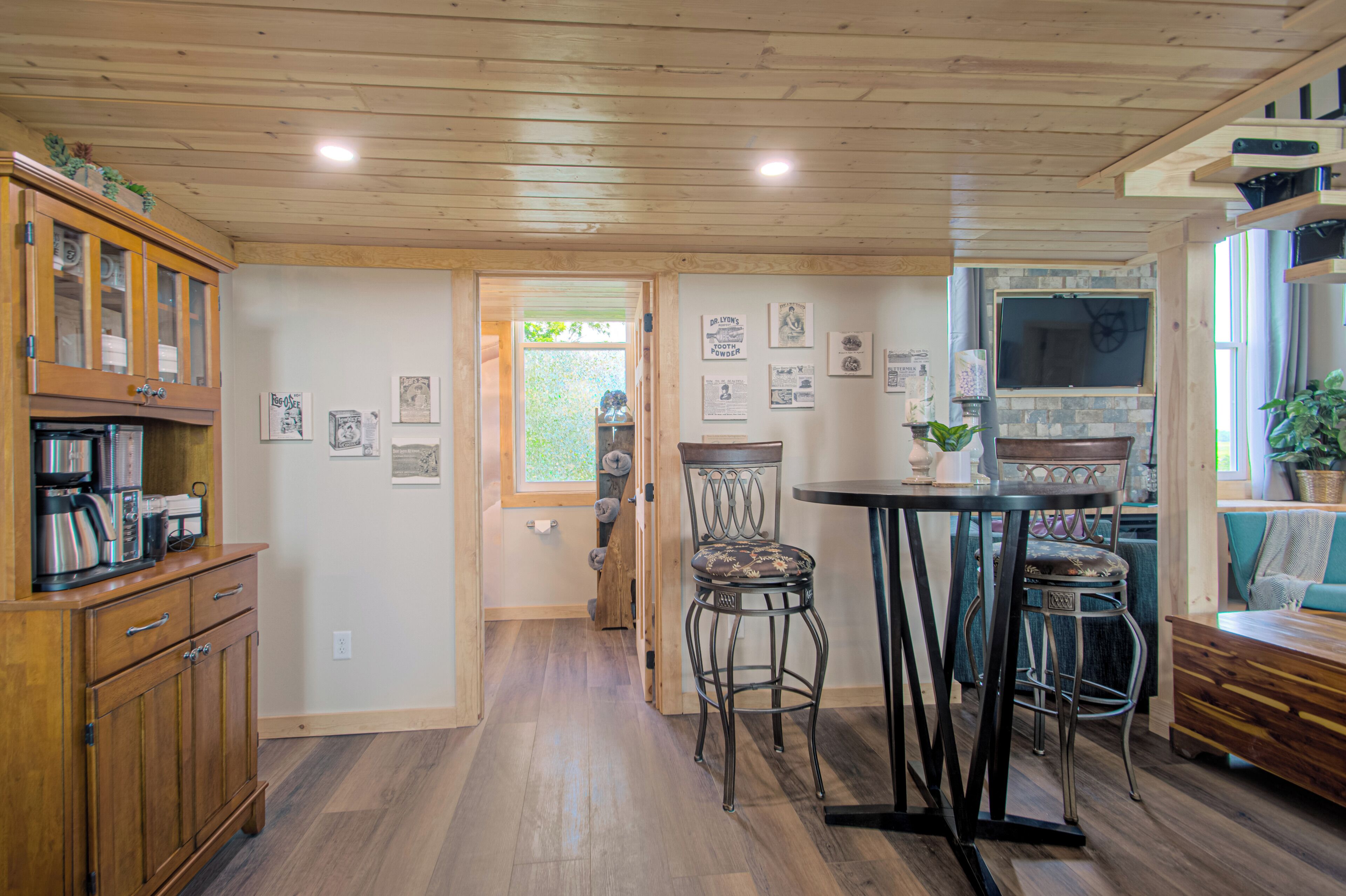 A kitchen with wooden cabinets, a dining table, and bar stools.