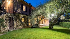 A stone house with a well-maintained lawn and a large tree in the foreground. - Villa Baia Blu 12, Emma Villas (Recco)