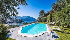 A swimming pool with a view of a coastal town and mountains. - Villa Baia Blu 12, Emma Villas (Recco)