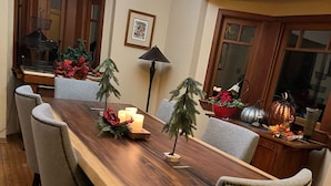 A dining area with a wooden table, six chairs, and a decorative centerpiece.
