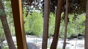 A concrete pathway leading to a natural area with trees and a stream. - Riverfront condo #3 w/patio, 1block 2 town,King bed,Wifi,20 min ski Granby Ranch (GRAND LAKE)