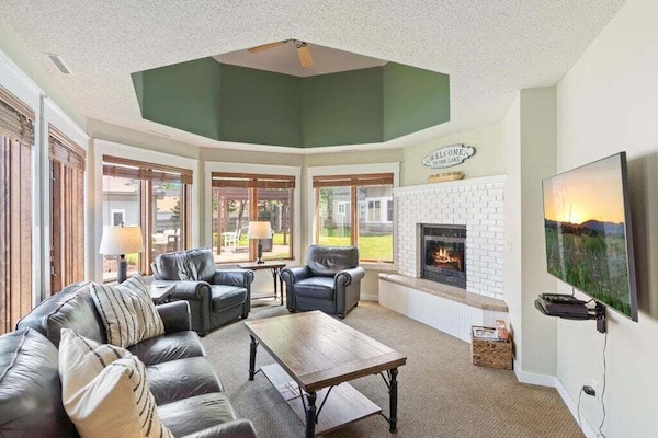 Cozy living room with plush seating, a warm fireplace, and large windows - perfect place to unwind after a day on the water | Gull Lake Rentals | Lakeside Rentals | Gull Lake, Minnesota