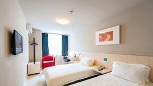 A hotel room with two beds, a desk, a chair, a TV, and a painting on the wall. - Jinjiang Inn (Wuhan Zhonghua Road, Yellow Crane Tower, Hubu Alley) (Wuhan)
