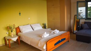 A bedroom with a bed, a nightstand, a mirror, and a wardrobe. - Villa "Sofia" with an amazing view at Angonas. (Agκona)