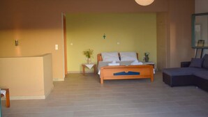 A bedroom with a bed, bedside table, and a nightstand. There is a chair and a lamp in the room. - Villa "Sofia" with an amazing view at Angonas. (Agκona)