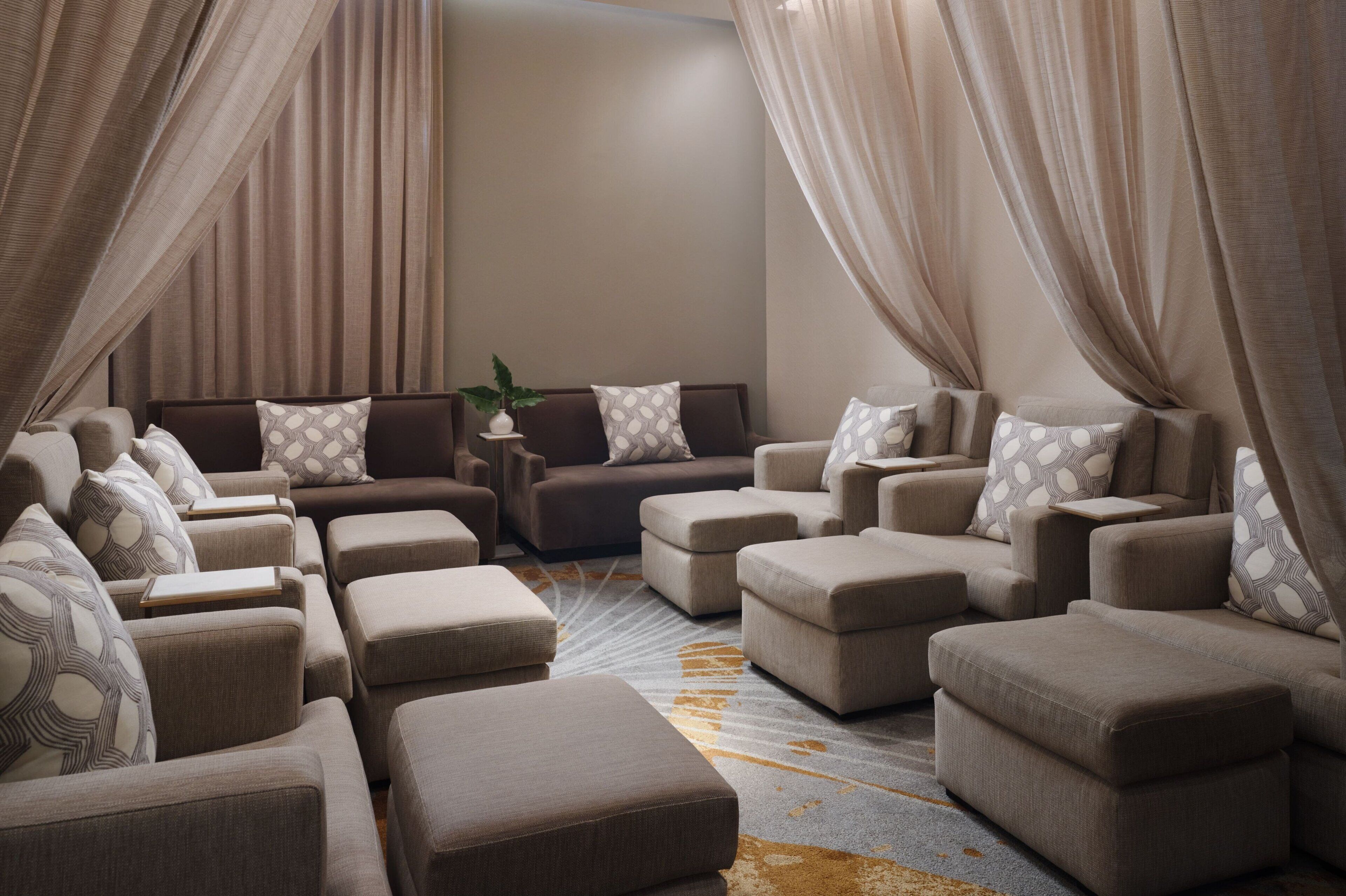 A modern living room with a sectional sofa, ottomans, and a coffee table.