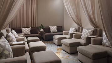 A modern living room with a sectional sofa, ottomans, and a coffee table.
