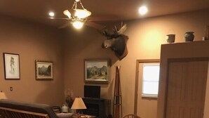 A cozy room with a wooden dining table, chairs, a bench, and a fireplace. - Beautiful bunkhouse in forest just hours outside Phoenix metro area (Strawberry)