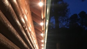 A wooden log cabin with a covered walkway and string lights. - Beautiful bunkhouse in forest just hours outside Phoenix metro area (Strawberry)