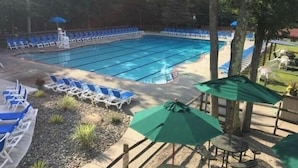 A swimming pool with blue chairs and a green umbrella. - Newly updated, great for multiple families up to 12 & pets; read reviews! (Clifton Township)