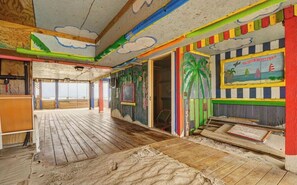 Adorned with vibrant tropical murals, this interior space offers a unique blend of indoor and outdoor views.