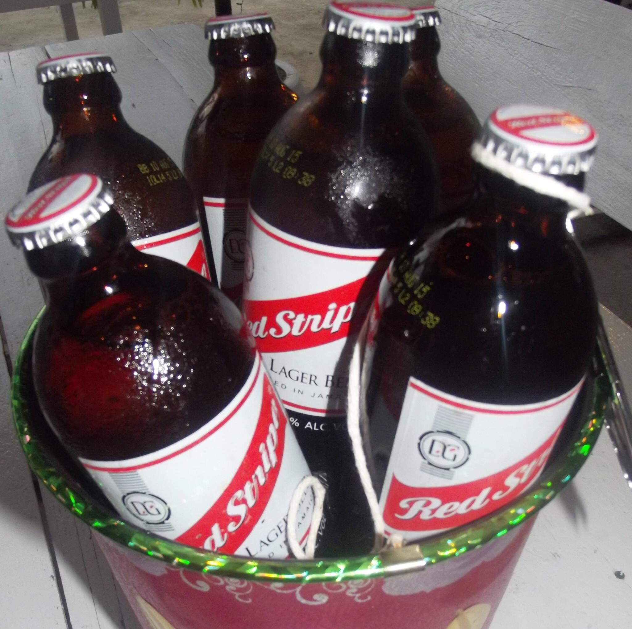 A bucket containing several bottles of Red Stripe beer.