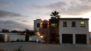 A modern two-story house with a stone facade, a covered patio, and a garage. - Million Dollar View! (Cabo San Lucas)