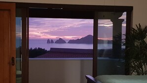 A balcony with a view of the sea and mountains at sunset. - Million Dollar View! (Cabo San Lucas)
