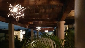 A covered outdoor area with wooden beams and columns, decorated with star-shaped lights. - Million Dollar View! (Cabo San Lucas)
