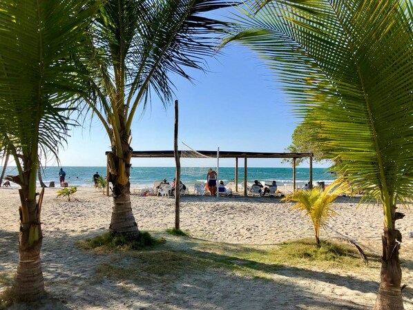 Am Strand, weißer Sandstrand, Strandtücher, Volleyball