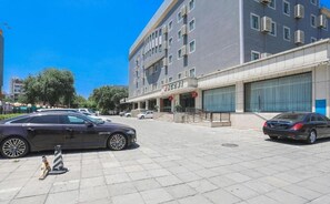 A modern building with a flat facade, multiple windows, and a gated entrance. - Jinjiang Inn Select (Beijing Wukesong) (Beijing)