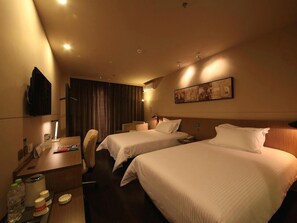 A hotel room with two beds, a desk with a chair, a television, and a painting on the wall. - Jinjiang Inn Select (Beijing Wukesong) (Beijing)