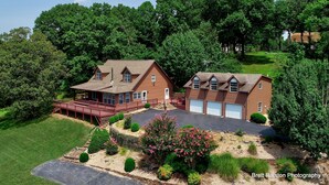 A two-story house with a covered porch and a garage.