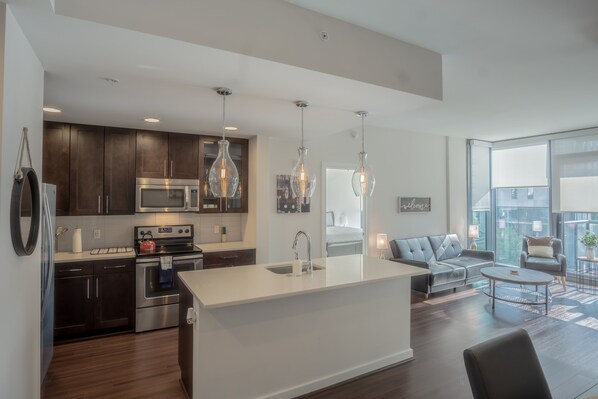 Enjoy a spacious kitchen with a central island, sink, and ample counter space, perfect for cooking and socializing.