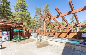 Relax by the pool surrounded by a natural setting and shaded by a pergola.