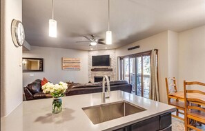 Enjoy cooking in the central island kitchen with an oven, microwave, and sink.