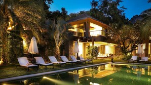 A modern two-story house with a swimming pool, surrounded by lush greenery and outdoor seating. - Sangsuri Villa 2 (Koh Samui)