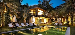 A modern two-story house with a swimming pool, surrounded by lush greenery and outdoor seating. - Sangsuri Villa 2 (Koh Samui)
