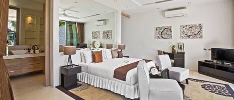 A modern bedroom with a large bed, bedside tables, a TV, and artwork on the walls.