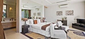 Une chambre à coucher moderne avec un grand lit, des tables de chevet, un téléviseur et des œuvres d’art accrochées aux murs.