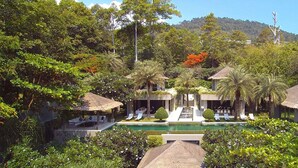 A resort with multiple thatched-roof structures, a central pool, and lush greenery. - Sangsuri Villa 3 (Koh Samui)