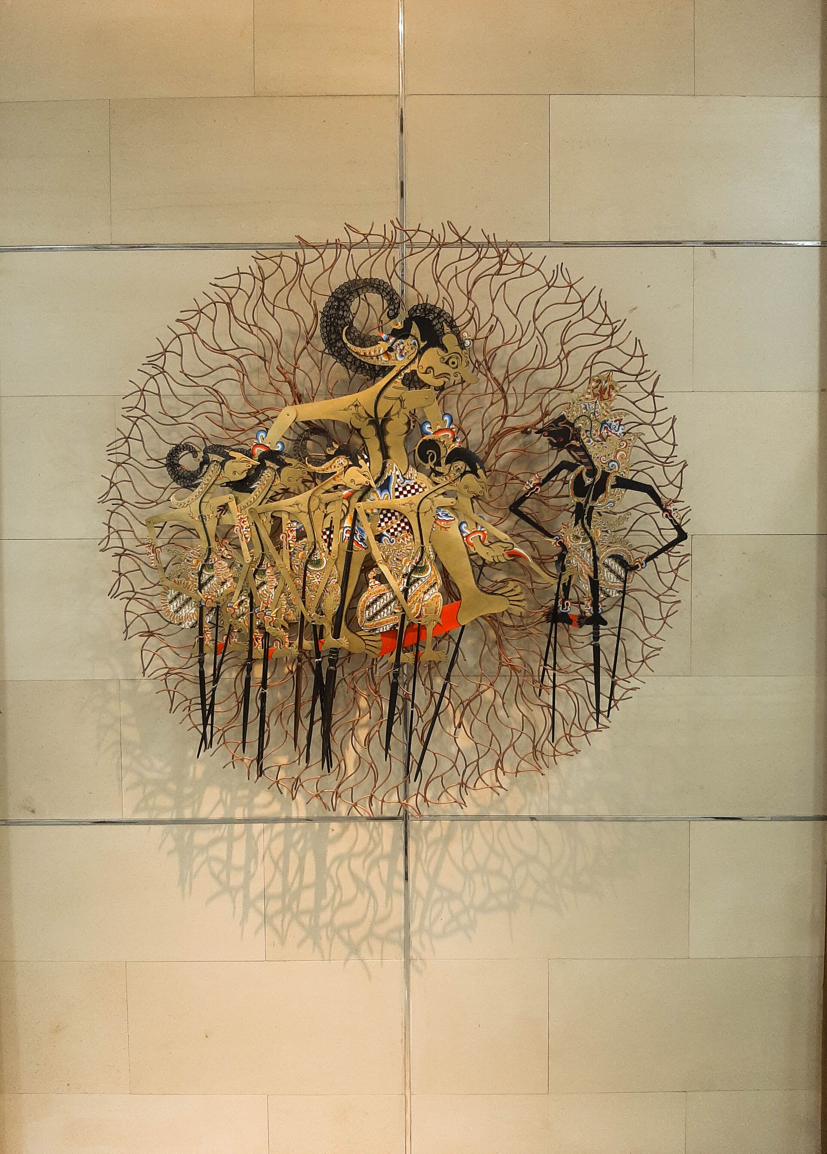 A wall-mounted sculpture with intricate designs and figures.