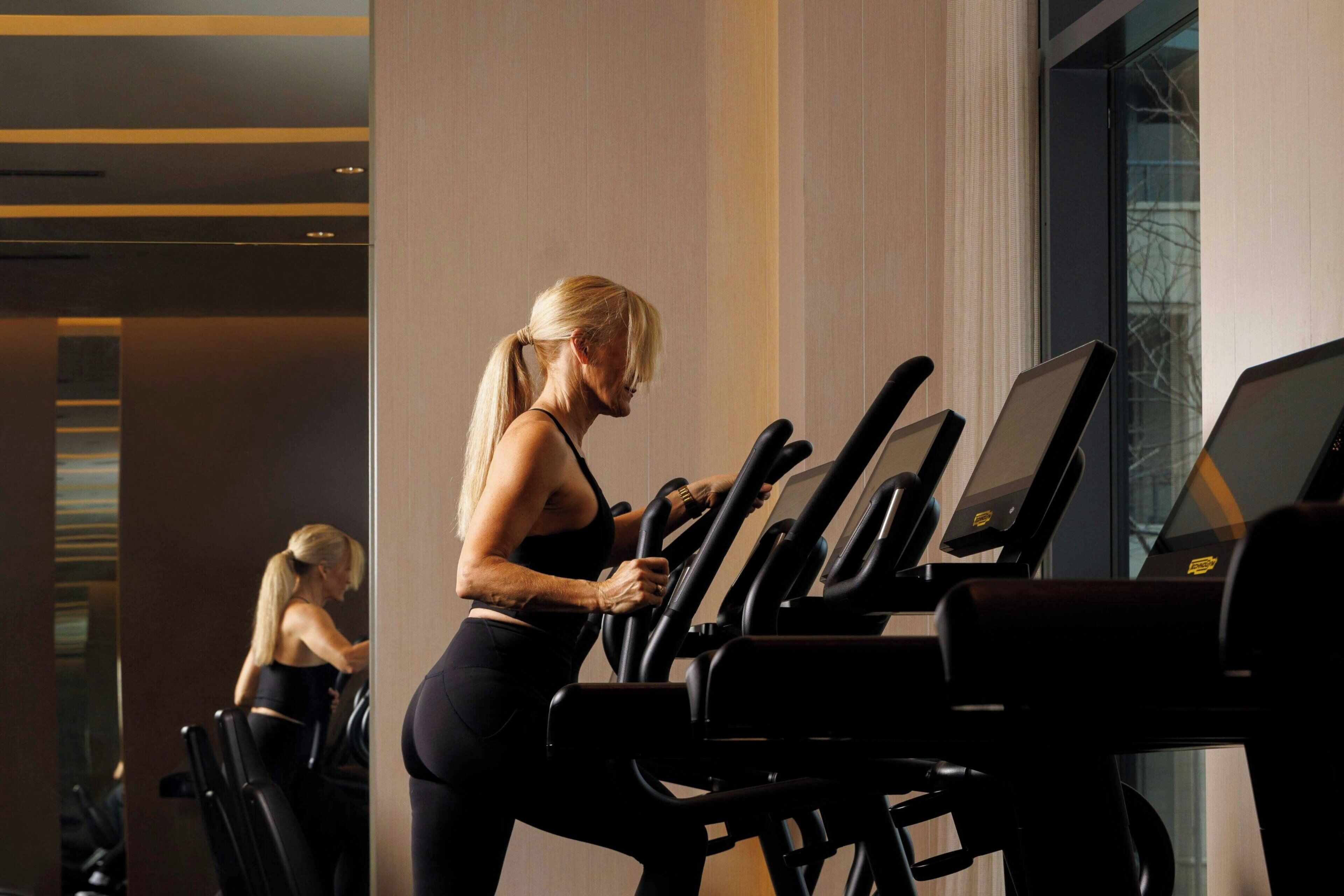 A gym with exercise equipment and a large window.