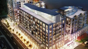 A modern hotel with multiple floors, a Marriott logo, and a waterfront view. - The Pearle Hotel & Spa, Autograph Collection (Burlington)