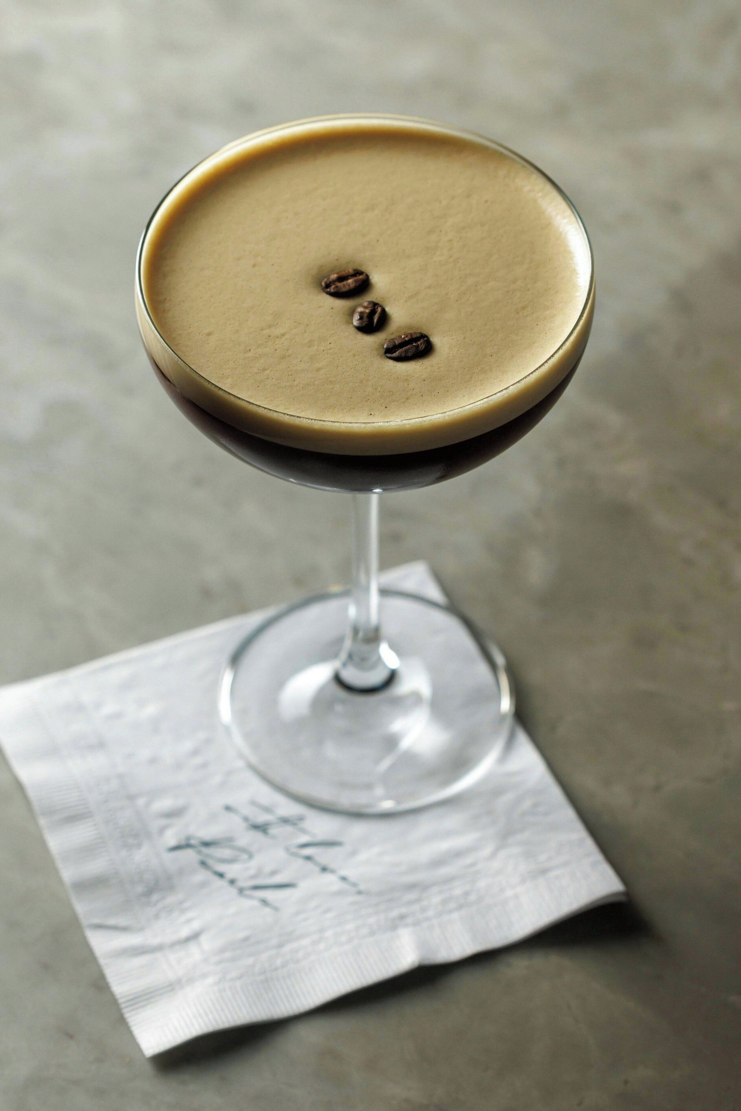 A martini glass with a golden rim on a textured surface.