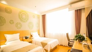 A hotel room with two beds, a desk, a chair, and a large window with curtains. - Greentree Inn Jinzhong Yuci Old Town (Jinzhong)