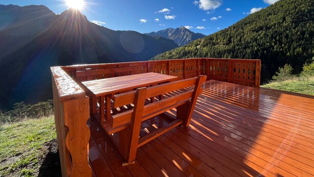 A wooden deck with a bench overlooking a mountainous landscape under a clear sky. - Chalet in Pra Loup 1500 with 4 bedrooms for 12 people (Pra-Loup)